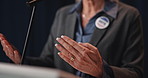 Politician, hands and woman with discussion for press conference, seminar or forum on stage. Legislator, speaker and announcement for official event, speech and policy update for mission and vote