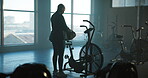 Ready, stationary bike and bag with woman in gym for exercise equipment, cardio and fitness. Begin, cycling machine and performance with person in sports center for wellness club and start training
