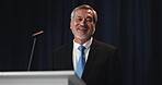 Stage, politician and man with smile, speech and pride for campaign, government policy and election. Public speaking, senator and mature person at event, presidential candidate and press conference