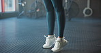 Workout, stretching and shoes of person in gym for warm up, training and fitness for marathon. Sports center, health club and feet of woman for performance, exercise and leg muscles for wellness