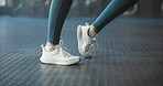 Ankle, warm up and feet of woman in gym for workout, exercise and fitness for marathon training. Sports center, health and shoes of person for wellness, strength and leg muscles for joint mobility