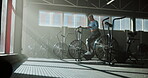 Stationary bike, workout and fitness with woman in gym for cardio, exercise machine and health. Training, cycling equipment and performance with person in sports club for energy and wellness