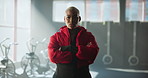 Arms crossed, face and non binary black person in gym for development, training or workout. Exercise, fitness and serious with androgynous athlete in health club for challenge, sports or wellness