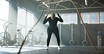 Fitness, woman and exercise with battle ropes at gym for power training, core strength or endurance. Health, athlete and weight equipment for bicep challenge, functional workout or muscle development