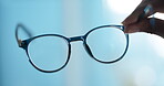 Eye care, glasses frame and hands with lens for eyesight correction, vision and refractive error. Optometry, person and blur spectacles for prescription eyewear, designer choice and medical insurance