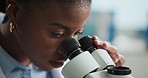 Black woman, scientist and microscope with forensic study for medical research or discovery in lab. Female person, DNA analyst or investigation with biotechnology for microorganisms or health results