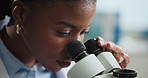 Black woman, microscope and scientist in lab for research with study, test or medical innovation. Biologist, science equipment or worker with analysis for biotechnology, experiment or healthcare
