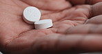 Hands, person and pills with healthcare, palms and wellness with clinic drug trial. Closeup, medical tablet and patient with medicine, pharmaceutical and dosage with pain relief and prescription