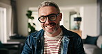 Face, smile and mature man in living room for relax, peace and calm in morning on weekend break. Glasses, portrait and happy person in home for funny humor, laugh or good mood in house in Switzerland