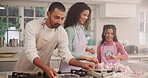 Parents, girl and baking cupcakes in home, happy and learning for skills, food or development in kitchen. Child, mother and father with teaching, dessert and smile for helping hand at family house