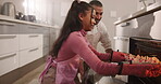 Man, daughter and cupcake in oven for baking, learning or help with support and bonding in home. Dad, girl kid and growth for bakery skills with family in kitchen for cake, baked goods and happiness