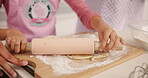 Hands, child and pin for baking in kitchen for learning, instructions and roll dough for cookies. Parents, help and kid with dessert guidance, teaching recipe and prepare for handmade snack at house
