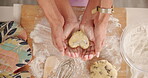 Hands, person and baking heart with child for learning, love shape cookies and bonding together. Above, parent and kid with dough for dessert, teaching recipe and helping for handmade snack at house