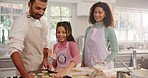 Parents, girl and cookie dough in kitchen, learning and smile with help for baking at home. Happy people, mother and daughter with father, bonding or teaching with biscuit ingredients in family house