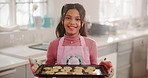 Girl, face and tray with cookies in kitchen with smile, excited and learning baking at house. Child, happy and portrait with biscuit, dessert or sweet snacks for cooking skills at apartment in Mexico