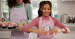 Girl, baking and eggs for cupcake in kitchen with parent, help and organic ingredients at family home. People, mother and daughter with skills, care or cooking with smile for muffins at apartment