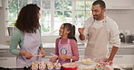 Parents, girl and laugh with baking, muffins and taste batter with smile, joke and bonding with love. People, mother and daughter with dad, playful and funny with teaching for cupcake at family house