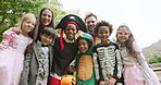 Halloween, costume party and family with kids in garden for celebration, bonding and fun together. Low angle, parents and excited children with hug for holiday portrait, vacation or festive tradition
