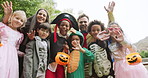 Halloween, face and kids waving with group outdoor, students and excited teachers. Holiday, celebration and portrait with happy children, people and costume with greeting for trick or treat basket