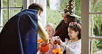 Children, happy or sweets at door on halloween for celebration, support and trick or treat. Holiday, people or excited with costumes in home for fantasy dress up, collecting candy or childhood memory