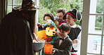 Children, group or sweets at door on halloween for tradition, celebration and trick or treat. Holiday, people or excited with costumes in home with candy bucket, fantasy dress up or neighborhood kids