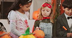Children, pumpkins and halloween with decor in costume for holiday preparation or pagan tradition. People, kids and dress up with decorations for christian culture, youth or party together in house