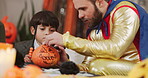Halloween, kids and drawing on pumpkin with father or parent for learning in home. Children, holiday and celebration with vegetable for decoration, writing or creative art with family at party
