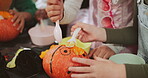 Halloween, hands and pumpkin carving with kids in home together for activity or tradition. Creative, holiday and vegetable with group of children in living room of apartment for spooky decoration