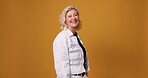Studio, face and mature woman with fashion, casual style and confidence or pride on orange background. Portrait, smile and happy model with trendy clothes, stylish outfit and space for aesthetic