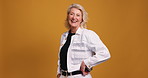 Laugh, face and mature woman for fashion, casual style and confidence on orange background. Portrait, smile and happy model for trendy clothes, stylish outfit or space for aesthetic in studio