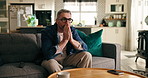 Disappointed, man and sport fan in home, watching tv and streaming match in lounge, unhappy and sad. Upset, supporter and mature person with remote in living room, soccer and frustrated by failure