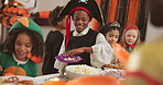 Candy, costume and halloween with group of kids in home for celebration, social or party. Eating sweets, food and snack with children friends in apartment together for event, holiday or tradition