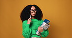 Woman, student and thinking with books in studio for scholarship application on a orange background. Female person, academic scholar or model in wonder for option, choice or decision on mockup space