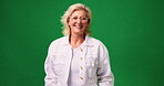 Studio, face and happy mature woman with fashion, casual style and confidence or pride on green background. Portrait, smile and happiness with trendy clothes, stylish outfit and space for aesthetic