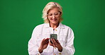 Studio, laughing and woman with smartphone, browsing and communication with contact on social media. Read, funny message and mature person with mobile, green background and texting with tech or space