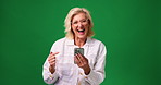 Face, smartphone and old woman in studio, smile and happiness on green background. Space, winning and elderly person with cellphone, excited and email for prize giveaway, victory and retirement