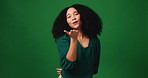 Face, blowing kiss and woman in studio, smile and romantic gesture on green background. Portrait, space and person with happiness, love and seductive with affection, sign and flirting with beauty