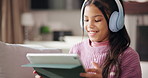 Tablet, headphones and happy kid in home for game, learning and streaming sound. Smile, technology and girl child with audio in living room for internet, app and play music for education on sofa