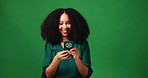 Phone, laughing and social media with black woman in studio for comedy, humor or meme reaction. App, communication and funny with African person isolated on green background for text message
