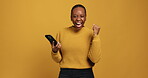 Studio, happy and woman with smartphone, face or excited for good news, mockup space or achievement. Yellow background, black person and smile for payment on mobile app, lottery winner and success