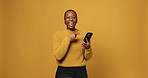 Woman, phone and point in studio, face or happy with choice for online shopping deal on yellow background. African person, smartphone and mockup space with app, ecommerce sale or promotion in Kenya