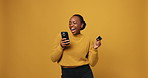 Black woman, phone and dancing with credit card, studio or online shopping deal on yellow background. African person, smartphone and celebration with fintech app, sale and mockup space for ecommerce