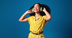 Happy woman, dancing and music with headphones in studio for audio streaming on a blue background. Female person, dancer and model with smile for sound, online subscription or vibe on mockup space