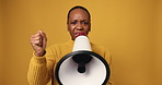 Megaphone, shouting and face of black woman in studio for protest, democracy or human rights activism. Portrait, bullhorn and African person with voice for politics with rally by yellow background.