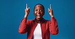 Face, laugh and black woman pointing up in studio for advertising, mockup or promotion coming soon. Portrait, excited and show space for marketing, sales discount or funny isolated on blue background