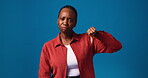 Woman, thumbs up and down for opinion, face or uncertain review, mockup or smile for recommendation. Studio, decision and black person with positive feedback or dislike, blue background and space
