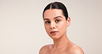 Face, serious and woman for beauty in studio with smooth textures, facial treatment and clear skin. Portrait, female person and skincare with natural shine, dermatology benefits and white background