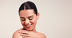 Shoulder, skincare and touch with woman in studio for beauty, body care and glow aesthetic. Collagen, dermatology and shine with person and hands on white background for mockup space and clear skin