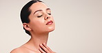 Hands, skincare and beauty with woman in studio for facial, self care and glow aesthetic. Collagen, dermatology and shine with person and touch on white background for mockup space and clear skin