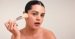 Blush, makeup brush and glow with face of woman in studio for cosmetic, beauty and aesthetic. Self care, foundation and space with person on white background for luxury, cosmetology and makeover tool